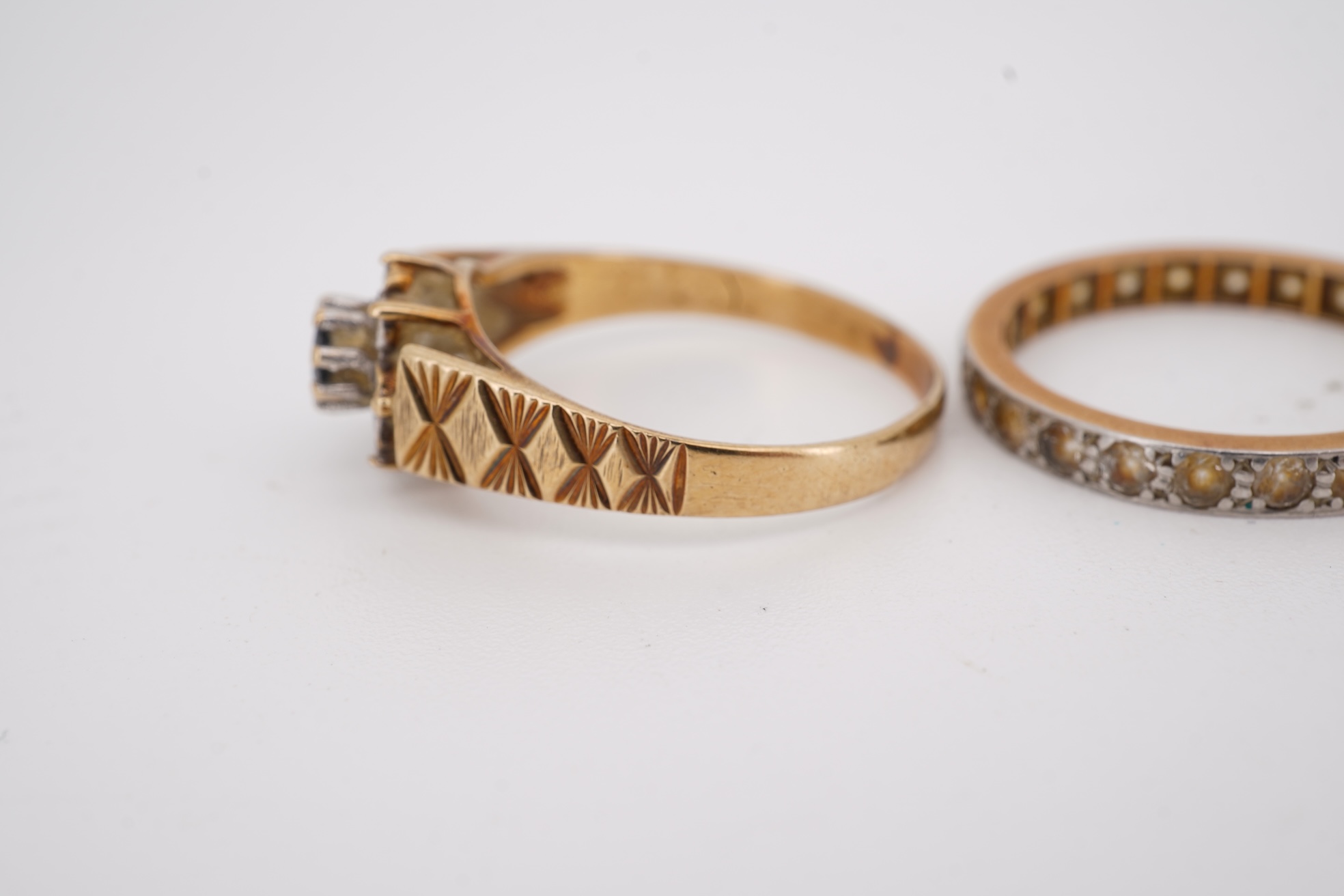 A 22ct wedding band, size M, 2 grams, an 18ct, plat and single stone diamond ring, a a modern 9ct gold, sapphire and diamond cluster ring and a yellow metal and white stone, eternity ring.